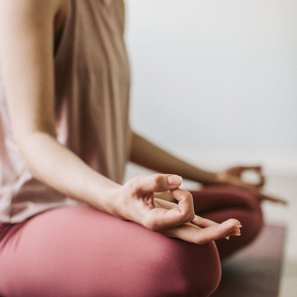 Woman in a seated meditation pose feeling serene and balanced.